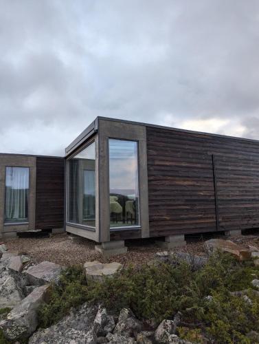 a house with large windows on the side of it at Pyhä Dreams in Pyhätunturi