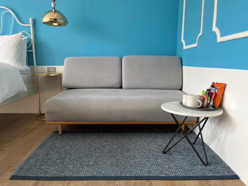 a couch sitting in a room with a table at Chill Roof Hotel in Taipei