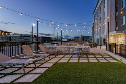 a patio with chairs and a table and lights at Everhome Suites Nampa Boise in Nampa
