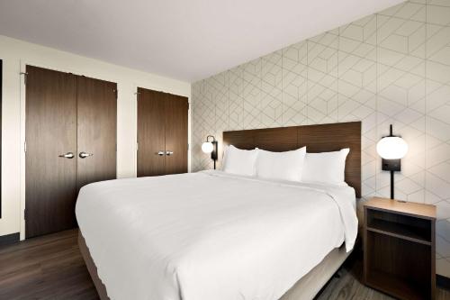 a large white bed in a hotel room at Everhome Suites Nampa Boise in Nampa