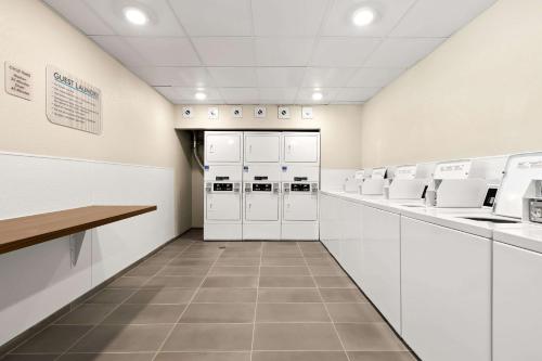 a laboratory with white cabinets and white appliances at Everhome Suites Nampa Boise in Nampa