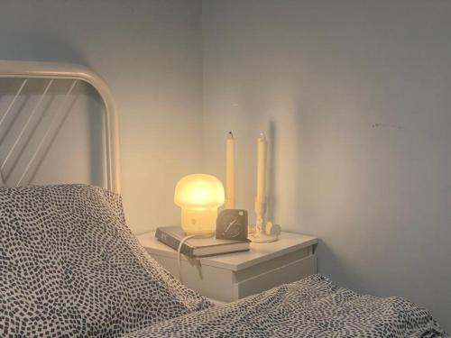 a bedroom with a bed with two candles and a clock at Shanghai Hills & Moment Family house close to The Bund in Shanghai