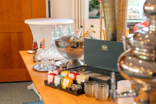 a table with a tray with bottles and glasses at Waldhotel Schäferberg in Espenau