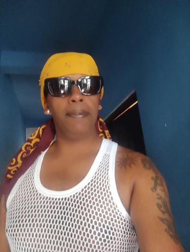 a woman wearing sunglasses and a yellow hat and a shirt at Hotel Athina & Restaurant in Chilaw