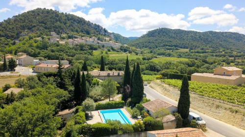 an aerial view of a villa with a pool and trees at La Bastide Bleue in Séguret