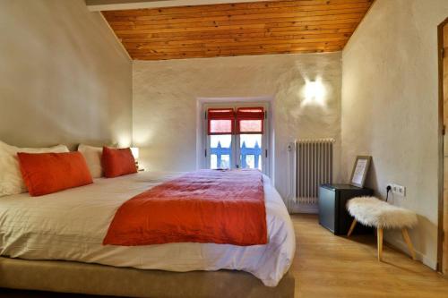 a bedroom with a large bed and a window at La Bastide Bleue in Séguret