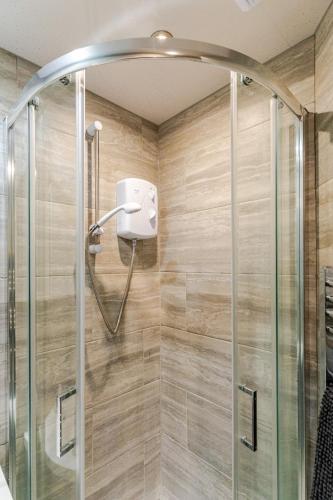 a shower in a bathroom with a glass shower stall at Cozy Flat in Walsall Town Centre in Walsall