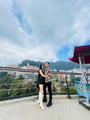 a man and a woman standing on top of a building at Orient Tam Đảo Hotel in Tam Ðảo