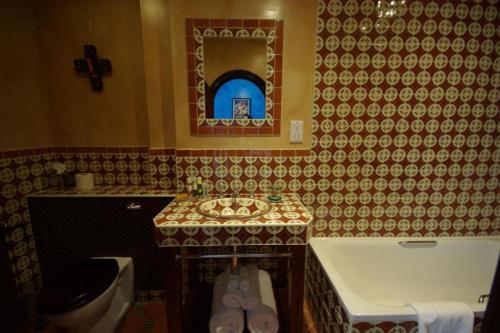 a bathroom with a tub and a sink and a mirror at Dancenter South London Camberwell in London