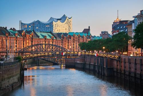 a bridge over a river in a city with buildings at Ibis Hamburg City in Hamburg