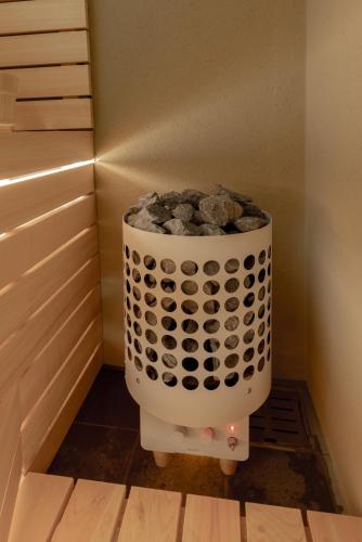 a bucket of rocks in a corner of a room at ZOPA Horikawa in Kanazawa
