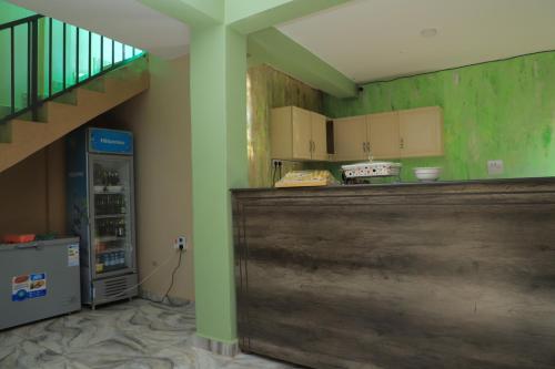 a kitchen with a counter and a refrigerator at Duggers Motel Lusaze in Kampala