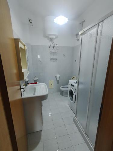 a bathroom with a sink and a washing machine at Villa Sole e Mare in Villa San Giovanni