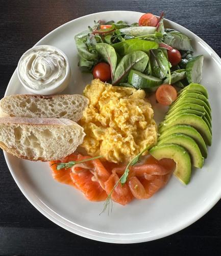 a plate of breakfast food with eggs and a salad at Be The One Hotel in Kyiv