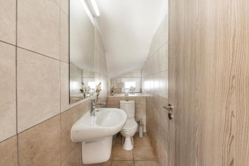 a bathroom with a white sink and a toilet at Villa Antonieta in Ayia Napa