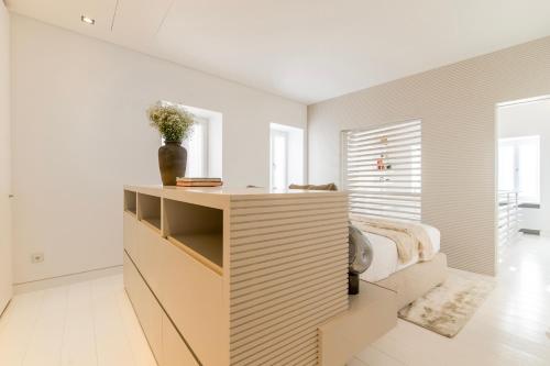a bedroom with a wooden dresser and a bed at Plaka Villa with Epic Acropolis Views in Athens