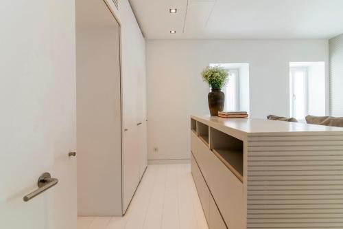 a kitchen with white walls and a counter with a vase on it at Plaka Villa with Epic Acropolis Views in Athens