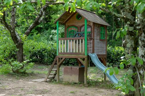 a wooden play house with a slide at Agriturismo Poggio Salvi in Sovicille
