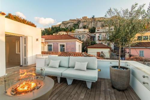 a balcony with a couch and a fire pit at Plaka Villa with Epic Acropolis Views in Athens