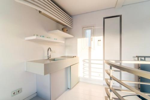 a kitchen with a sink and a staircase at Plaka Villa with Epic Acropolis Views in Athens