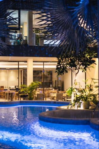 a large swimming pool in front of a building at Stay Collection Nimman Chiangmai in Chiang Mai
