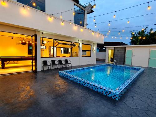 a swimming pool in the backyard of a house at SunsetChalet 25pax Pool Snooker Bathtub Playground in Kluang