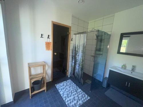 a bathroom with a shower and a sink at Kopli puhkemaja Saaremaal in Kasti