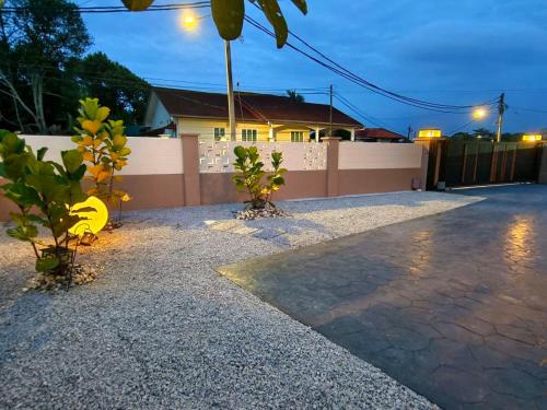 a driveway with plants in front of a house at SunsetChalet 25pax Pool Snooker Bathtub Playground in Kluang