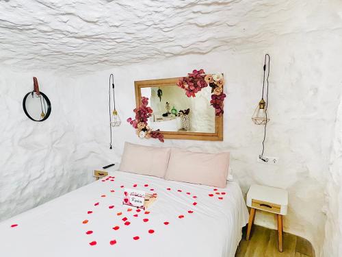 a bedroom with a bed with red hearts on it at Casa Rural Las Colmenas in Alcalá del Júcar