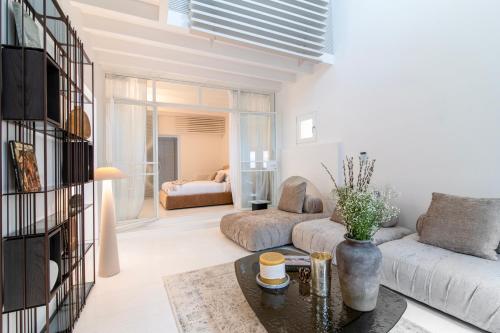 a living room with a couch and a table at Plaka Villa with Epic Acropolis Views in Athens