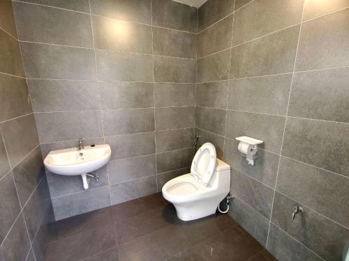 a bathroom with a toilet and a sink at SunsetChalet 25pax Pool Snooker Bathtub Playground in Kluang