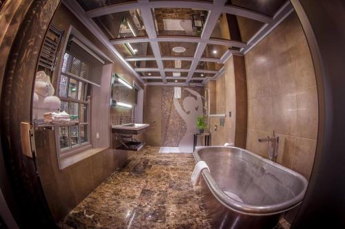 a large bathroom with a tub and a window at Me & Mrs Jones in Portstewart