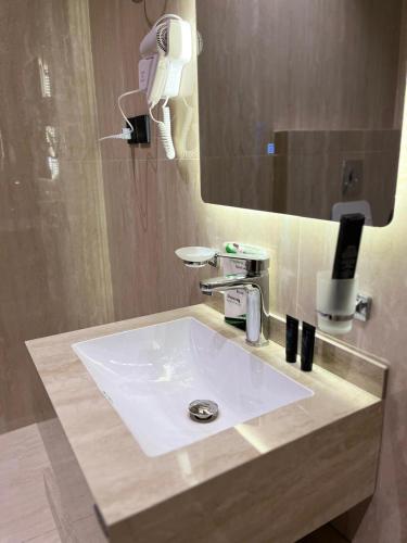 a bathroom with a white sink and a mirror at Studio Sulimaniyah in Riyadh