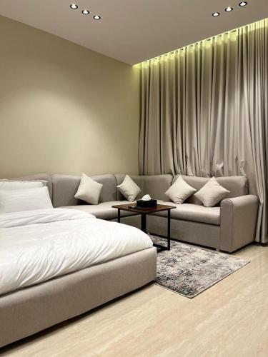 a living room with a bed and a couch at Studio Sulimaniyah in Riyadh