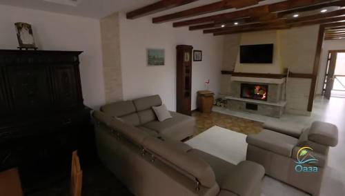 a living room with a couch and a fireplace at Etno selo Katunija in Katun