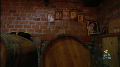 a room with a brick wall and two wooden barrels at Etno selo Katunija in Katun