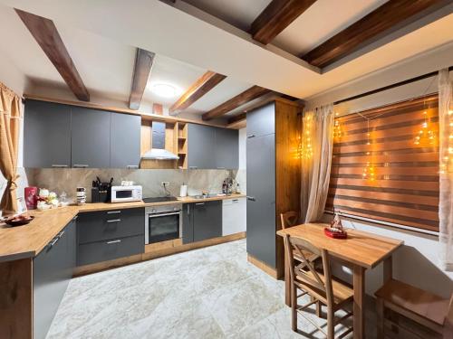 a kitchen with blue cabinets and a wooden table at Etno selo Katunija in Katun