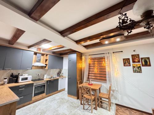 a kitchen with a table and chairs in a room at Etno selo Katunija in Katun