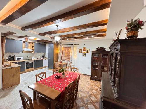 a kitchen and dining room with a table and chairs at Etno selo Katunija in Katun