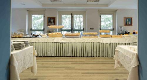a large room with a table with food on it at Hotel Delle Rose in Cascia