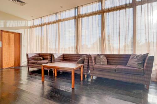 a living room with a couch and a coffee table at Dancenter near Stoke On Trent former Holiday Inn in Crewe