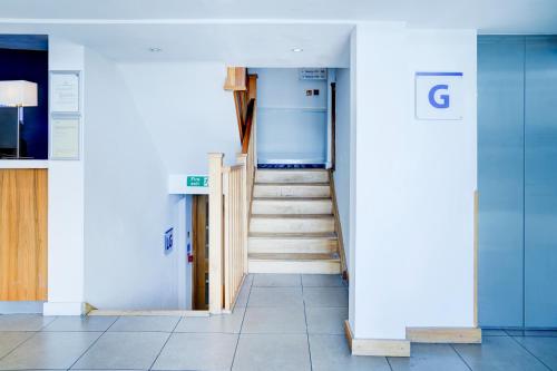 a hallway with a staircase in a building at Dancenter near Stoke On Trent former Holiday Inn in Crewe