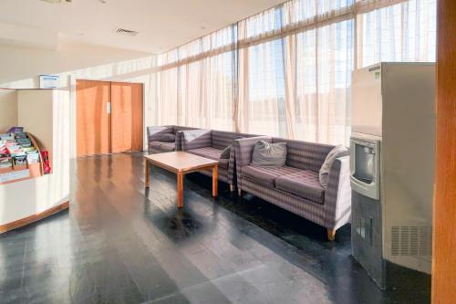 a living room with a couch and a table at Dancenter near Stoke On Trent former Holiday Inn in Crewe