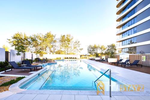 a swimming pool with chairs and a building at Pretty in Phillip - 2bd 2bth 2Car Apt in Phillip