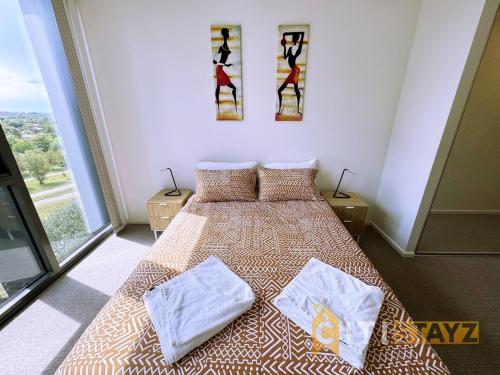 a bedroom with a bed with two towels on it at Pretty in Phillip - 2bd 2bth 2Car Apt in Phillip