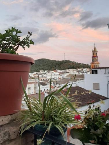 a view of a city from a balcony with a clock tower at Casa Rural Casita de Chocolate in Constantina