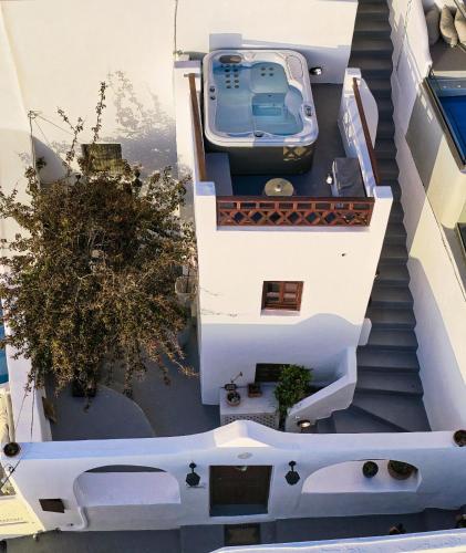 an overhead view of a house with a car on the stairs at Ducato Dream jaccuzi Suite Imerovigli Santorini in Imerovigli