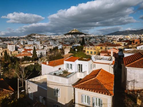 a view of a city with houses and roofs at Plaka Villa with Epic Acropolis Views in Athens