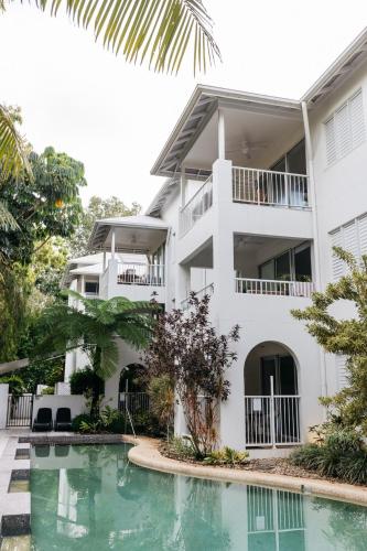 an apartment building with a swimming pool in front of it at Portsea 74 - Live a little in Port Douglas