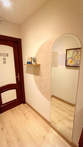 an empty room with a door and a mirror at I Mosaici Guesthouse Luxury Apartment in Ronco Scrivia